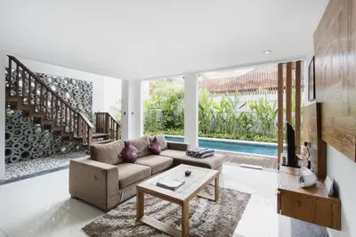 a living room with a couch and a table at Delu Villas & Suite in Kerobokan