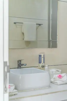 a bathroom counter with a sink and a mirror at VILLA BALI OM CENTER - Best Location, Beautiful Villa Near the Beach in Canggu