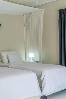 two beds sitting next to each other in a bedroom at VILLA BALI OM CENTER - Best Location, Beautiful Villa Near the Beach in Canggu