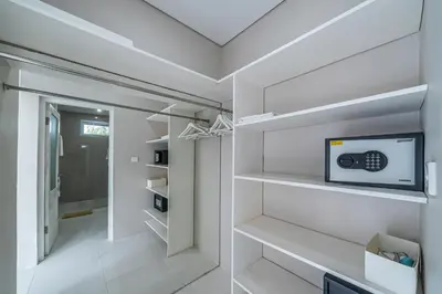 a walk in closet with white walls and white shelves at VILLA BALI OM CENTER - Best Location, Beautiful Villa Near the Beach in Canggu