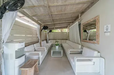 a living room with white couches and a table at VILLA BALI OM CENTER - Best Location, Beautiful Villa Near the Beach in Canggu