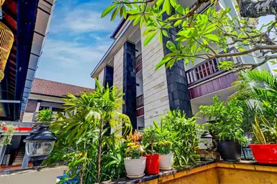 a balcony with plants inront of a building at Collection O Bali near Kedonganan Beach formerly New Asta Graha Homestay in Jimbaran