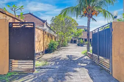 an open gate in a street with a fence at Collection O Bali near Kedonganan Beach formerly New Asta Graha Homestay in Jimbaran