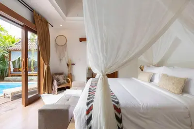 a bedroom with a bed and a pool at Elvano villa in heart of seminyak and near beach in Seminyak