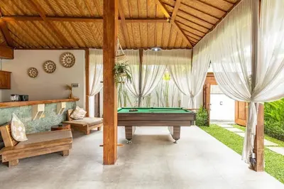 a living room with a pool table in a room at Elvano villa in heart of seminyak and near beach in Seminyak
