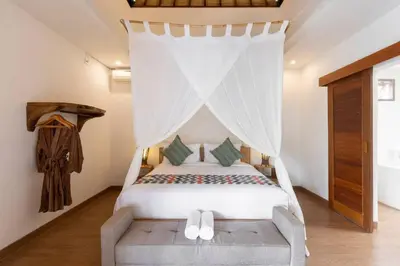 a bedroom with a bed with a canopy at Elvano villa in heart of seminyak and near beach in Seminyak