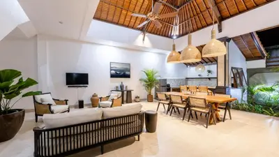 an open living room with a table and chairs at Villa Casa Orana in Seminyak
