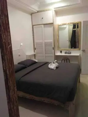 a bedroom with a bed with a stuffed animal on it at Blue Lagoon 5 bedrooms Villa in Kuta