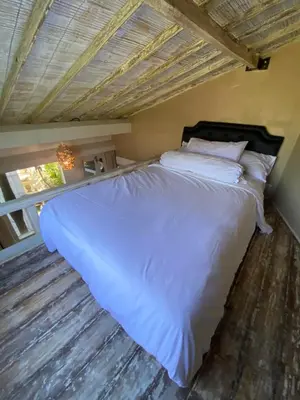 a bedroom with a large white bed and a window at Blue Lagoon 5 bedrooms Villa in Kuta
