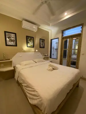a large white bed in a room with a window at Blue Lagoon 5 bedrooms Villa in Kuta