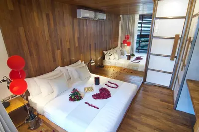 a bedroom with a white bed with decorations on it at 4BR Villa Jumat - Minggu Villas Seminyak in Seminyak