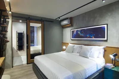 a bedroom with a large white bed in a room at 4BR Villa Jumat - Minggu Villas Seminyak in Seminyak