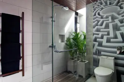 a bathroom with a shower with a toilet and a plant at 4BR Villa Jumat - Minggu Villas Seminyak in Seminyak