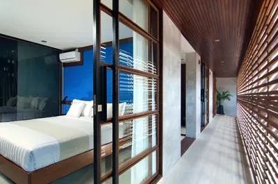a bedroom with a bed and a large window at 4BR Villa Jumat - Minggu Villas Seminyak in Seminyak