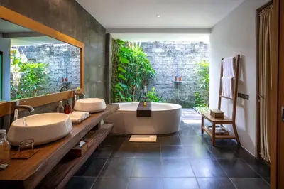 a bathroom with two sinks and a bath tub at Villa Kapungkur in Jimbaran