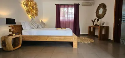a bedroom with a bed and a window with purple curtains at Villa Floppy New 1 bedr villa private Pool 5min beach in Legian