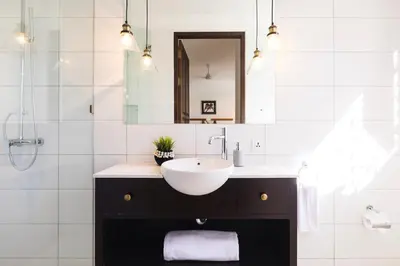 a bathroom with a sink and a mirror at Villa Toru - Stylish luxury in Legian, tranquil location, walk to beach in Legian