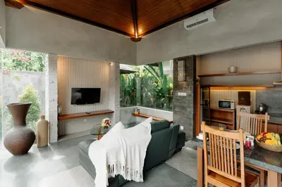 a living room with a couch and a table at Bracha Villas Bali in Seminyak