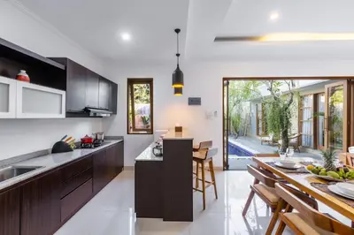 a kitchen and dining room with a table and chairs at Bali Voyage in Seminyak