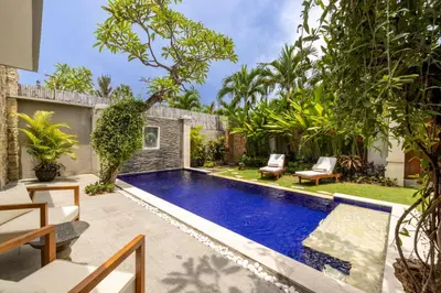 a swimming pool in the backyard of a house at Bali Voyage in Seminyak