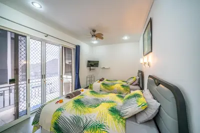 a bedroom with a bed with a colorful comforter at Modern villa with private pool , full kitchen and parking in Legian