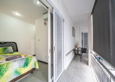 a bedroom with a bed and a balcony at Modern villa with private pool , full kitchen and parking in Legian