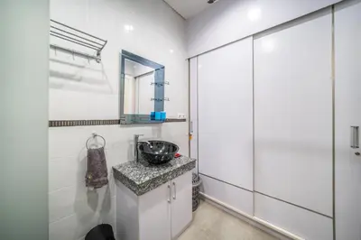 a bathroom with a sink and a mirror at Modern villa with private pool , full kitchen and parking in Legian