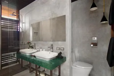 a bathroom with a sink and a toilet and a mirror at 4BR Villa Kamis - Minggu Villas Seminyak in Seminyak