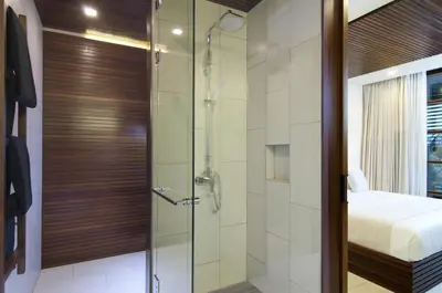 a shower with a glass door in a bathroom at 4BR Villa Kamis - Minggu Villas Seminyak in Seminyak
