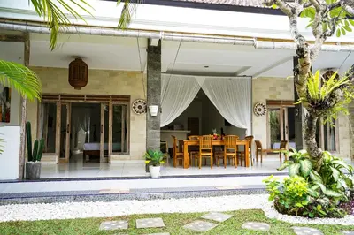 a patio with a table and chairs on a house at Villa Polly in Seminyak
