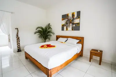 a bedroom with a bed with flowers on it at Villa Polly in Seminyak