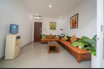 a living room with a couch and a table at Cozy Umalas Guesthouse in Kerobokan