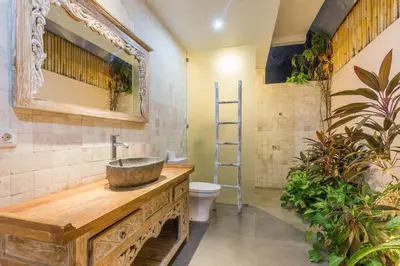 a bathroom with a sink and a toilet at Villa Maloa in Denpasar