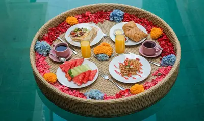 a table with plates of food on a table at Villa Sunset by Premier Hospitality Asia in Nusa Dua