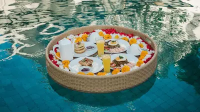 a tray of food in the water in a pool at Villa Sunset by Premier Hospitality Asia in Nusa Dua