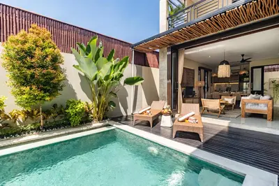 a swimming pool in a backyard with a house at NEWLY RENOVATED trendy 4bd Pvt villa in Seminyak in Seminyak