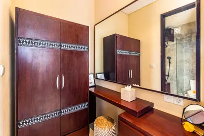 a bathroom with a wooden cabinet and a mirror at NEWLY RENOVATED trendy 4bd Pvt villa in Seminyak in Seminyak