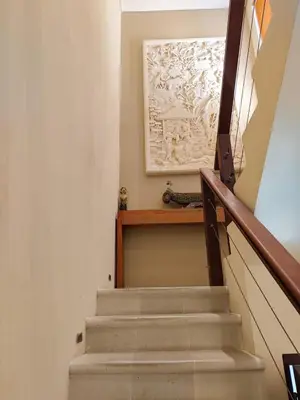 a stairway with a picture on the wall at The Oasis Retreat Seminyak in Seminyak