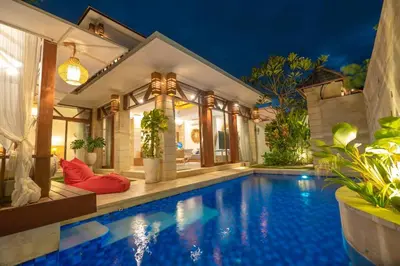 a swimming pool in front of a house at Miracle villa Canggu in Canggu