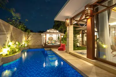 a swimming pool in a backyard with a gazebo at Miracle villa Canggu in Canggu
