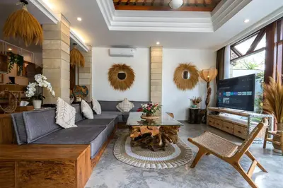 a living room with a couch and a table at Miracle villa Canggu in Canggu