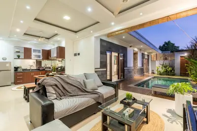 a living room with a couch and a swimming pool at Villa Estella ☆ Seminyak Kuta - Private Pool in Seminyak