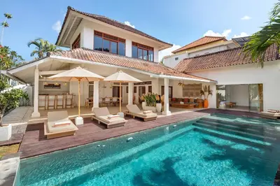 a villa with a swimming pool and a house at Villa Lisabella by Villa Finder in Seminyak