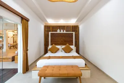 a bedroom with a king sized bed and a glass door at Villa Lisabella by Villa Finder in Seminyak