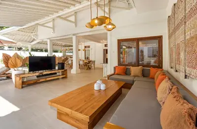 a living room with a couch and a tv at Villa Lisabella by Villa Finder in Seminyak