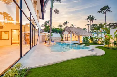 an exterior view of a house with a swimming pool at Villa Dublin - Luxury 5 BDR w Jacuzzi & Pool in Seminyak