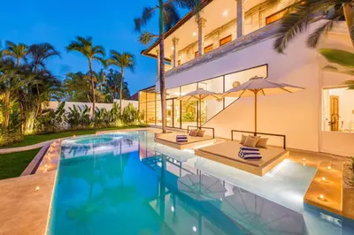 an exterior view of a house with a swimming pool at Villa Dublin - Luxury 5 BDR w Jacuzzi & Pool in Seminyak