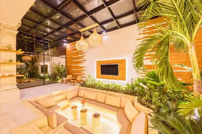 a living room with a couch and some plants at Villa Dublin - Luxury 5 BDR w Jacuzzi & Pool in Seminyak