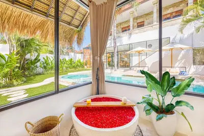 a bathtub filled with red sand in a room with windows at Villa Dublin - Luxury 5 BDR w Jacuzzi & Pool in Seminyak