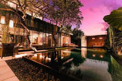 a swimming pool in the middle of a house at Sunset Palms Beach Villa in Jimbaran